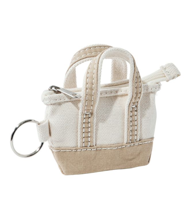 Small beige bag with a zipper and key ring on a white background