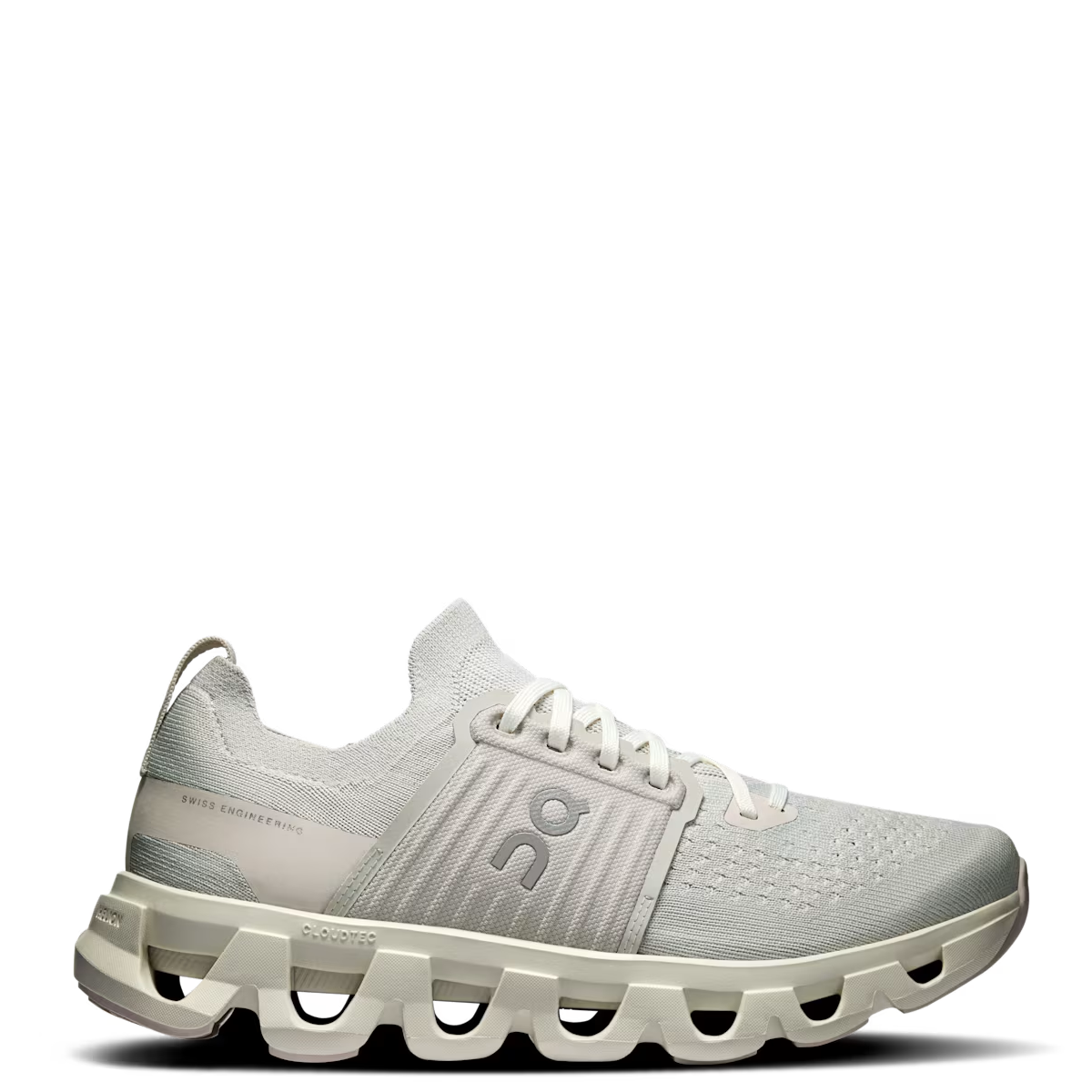 A pair of women's running shoes with a white and gray color scheme, featuring a round toe box, perforated toe area, and a thick sole with a rockered geometry design.