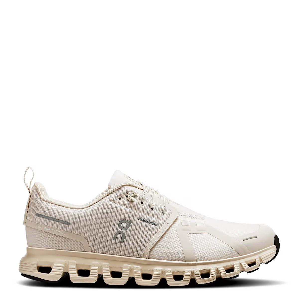 A pair of beige women's running shoes with a waterproof membrane and a cushioned sole.