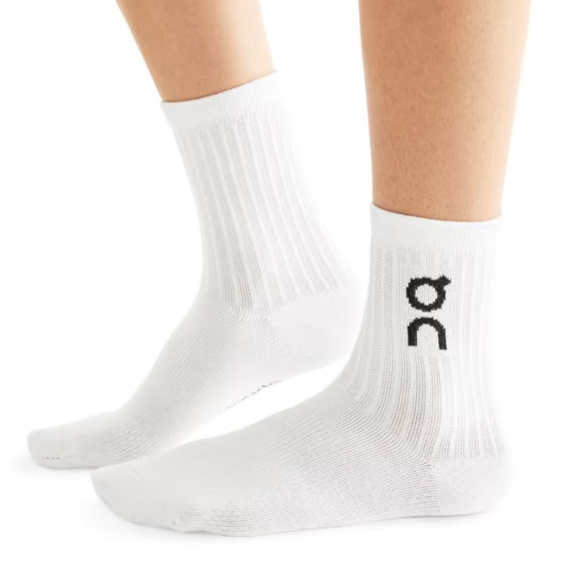 A pair of  adult crew length white socks with a black On Running logo on a white background