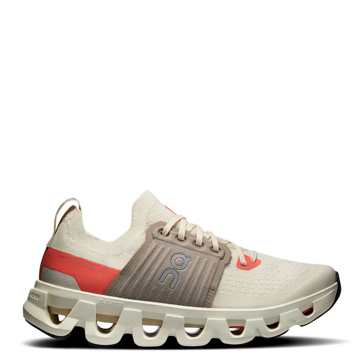A pair of women's running shoes with a beige, red, and gray color scheme, featuring a wave-like design on the sole and a lace-up closure.