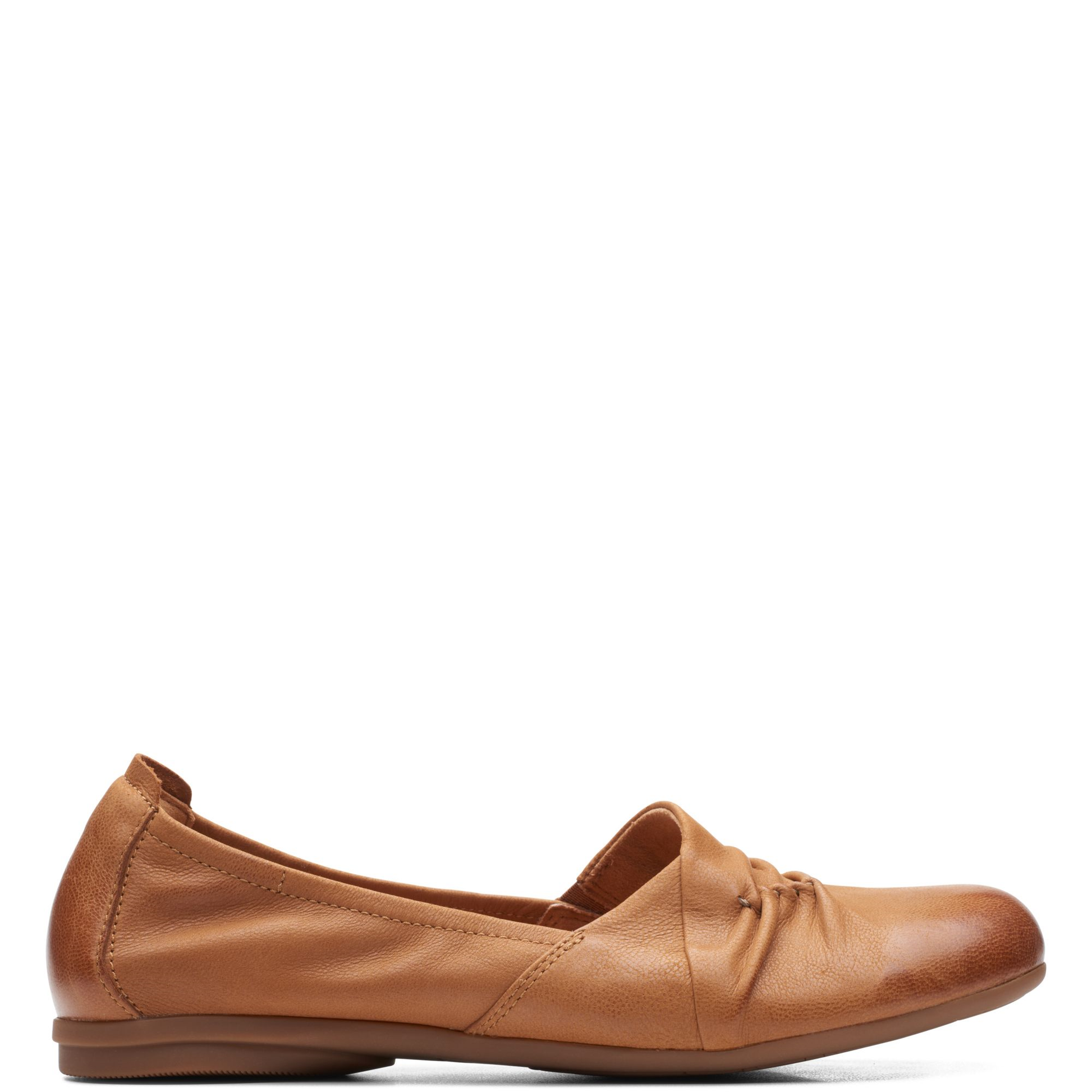 A pair of women's brown flat shoes with a hook and loop closure at the toe and a flat sole.
