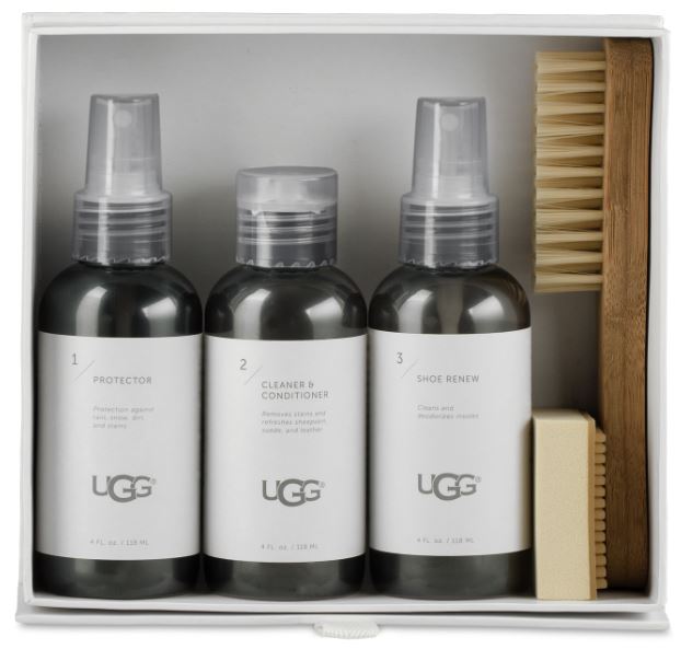 A set of UGG branded shoe care products, including spray bottles for Protector and Cleaner & Conditioner, a Shoe Renew freshener, a brush, and a scuff eraser, all displayed in a white box.