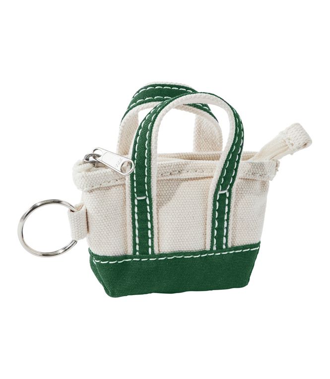 Small white and green bag keychain on a white background