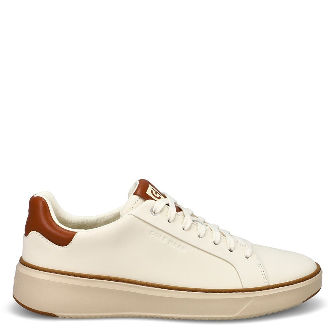 White sneaker with brown accents on a white background