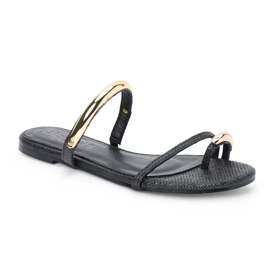 Black sandal with gold straps on a white background