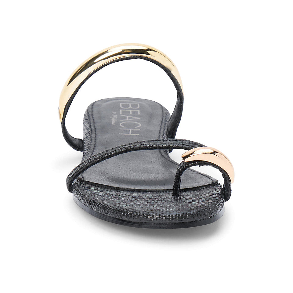 Black sandal with gold straps on a white background