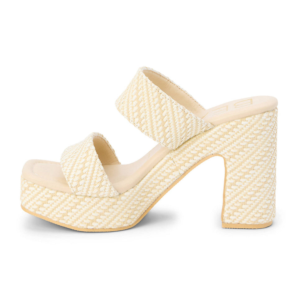 Cream-colored woven sandal on a white background