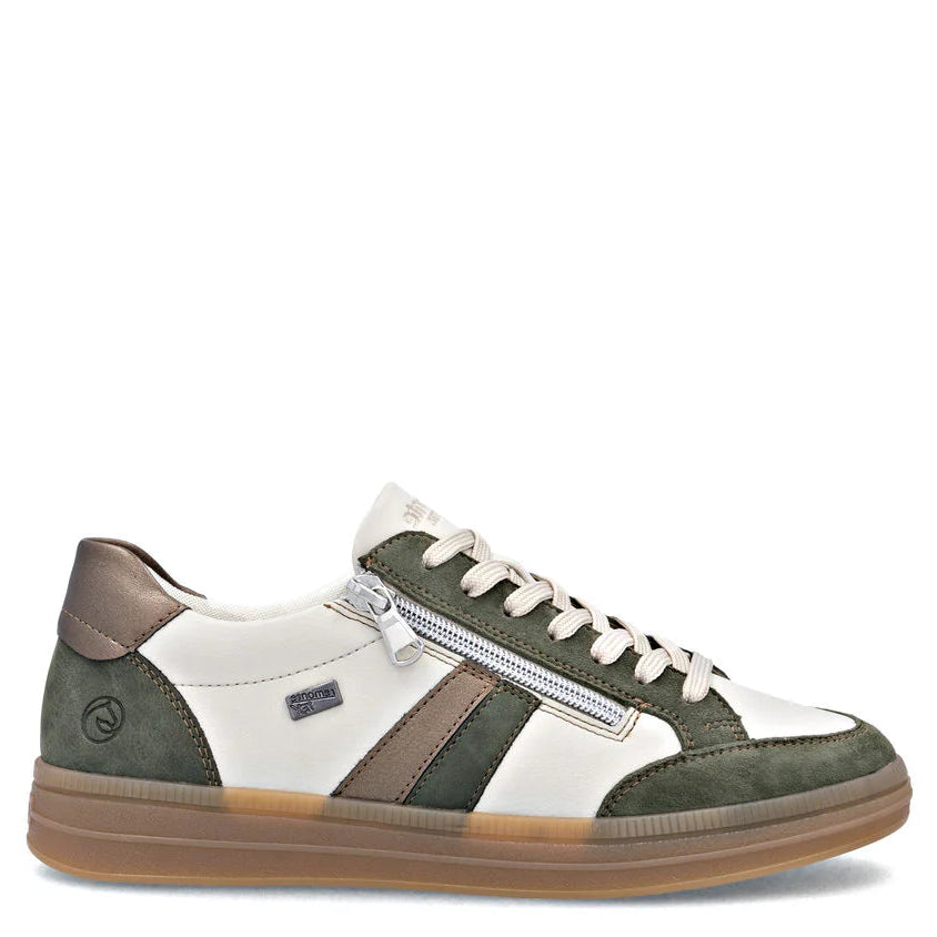 Green and white sneaker with a brown sole on a white background