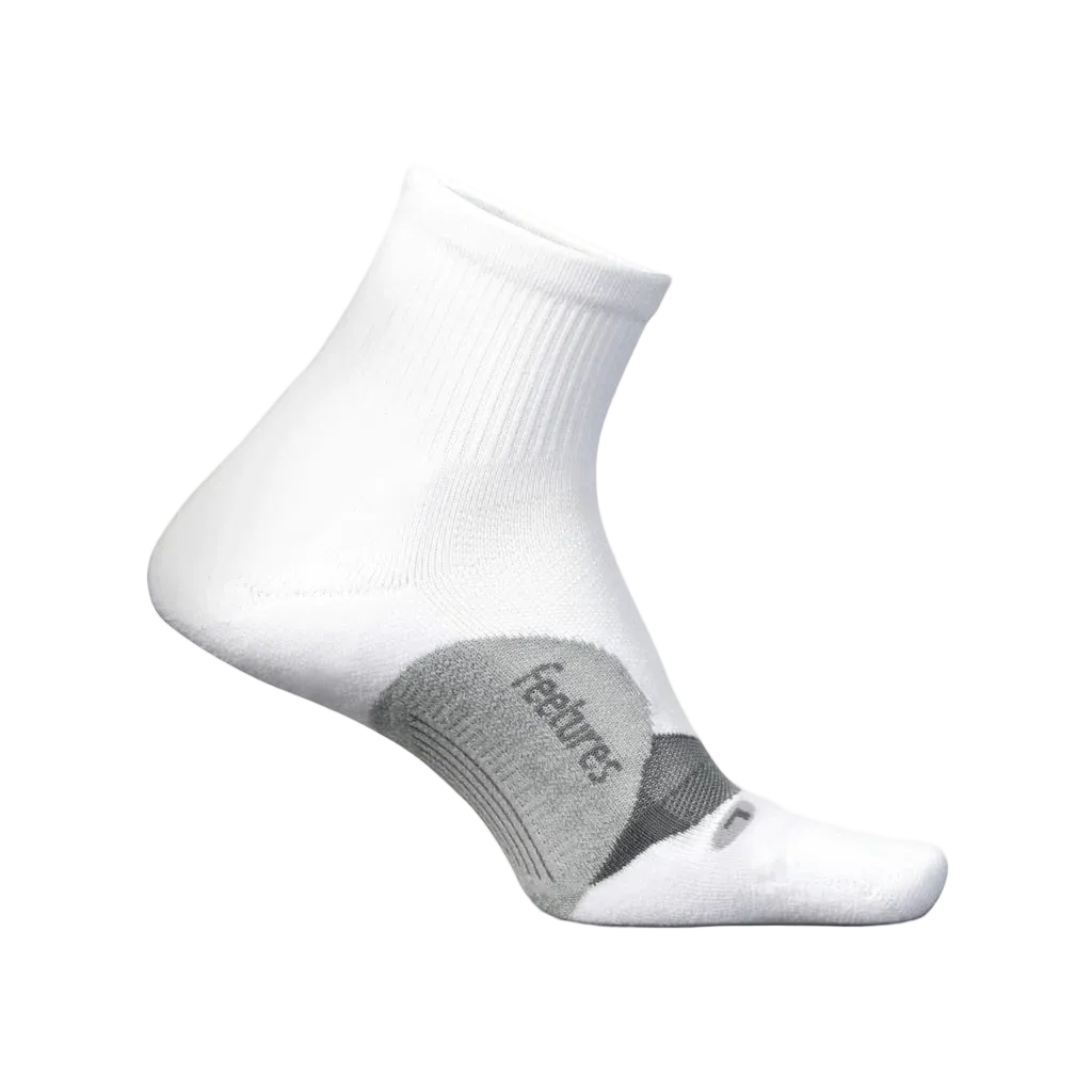 White sock with gray heel and toe area on a light beige background