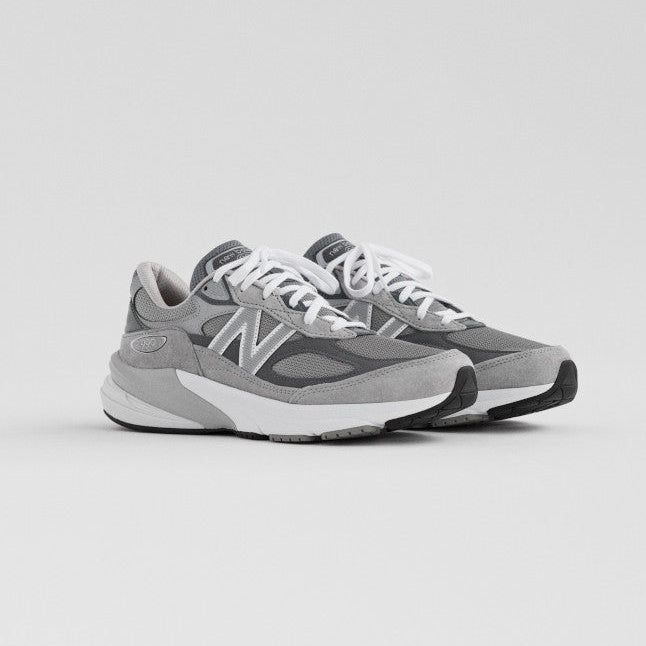 Gray sneakers with white soles on a light gray background