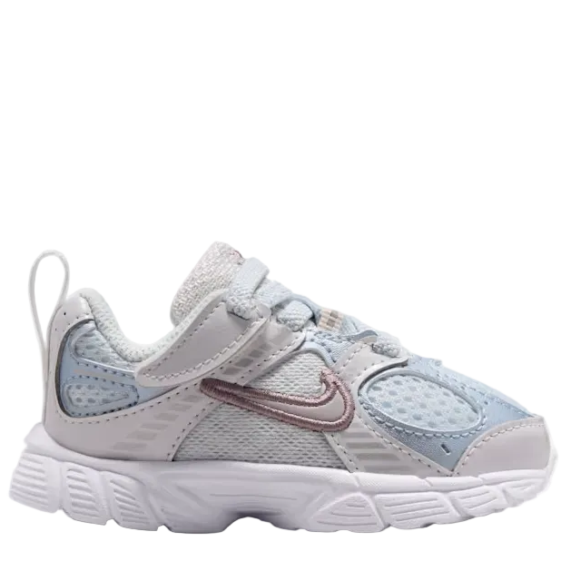 A Nike toddler sneaker in light gray and white mesh with a dusty rose metallic swoosh and light blue mesh panels on the side, shown against a plain white background.