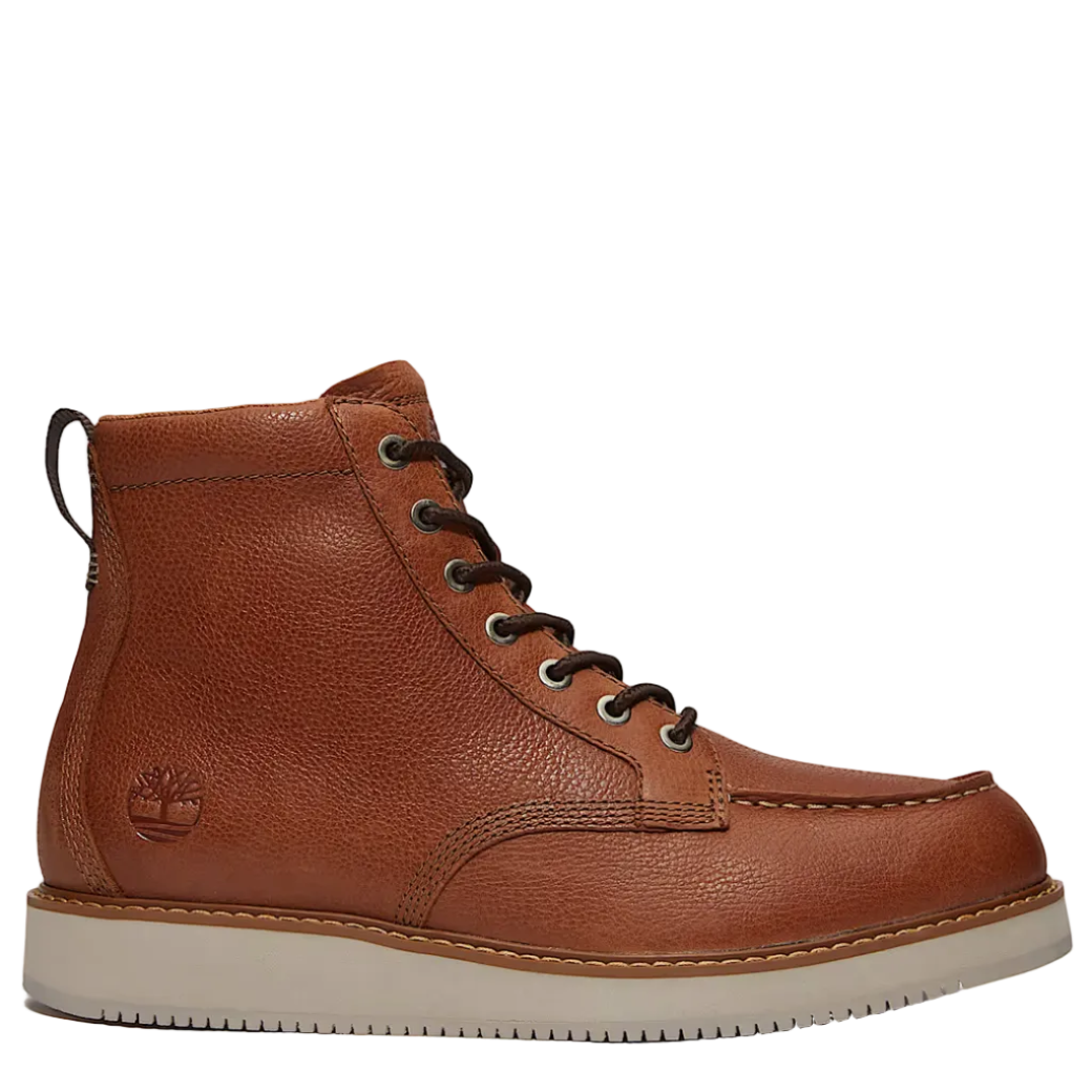Brown leather boot with a white sole on a light gray background