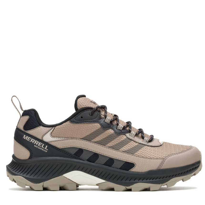 Beige and black Merrell hiking shoe on a white background