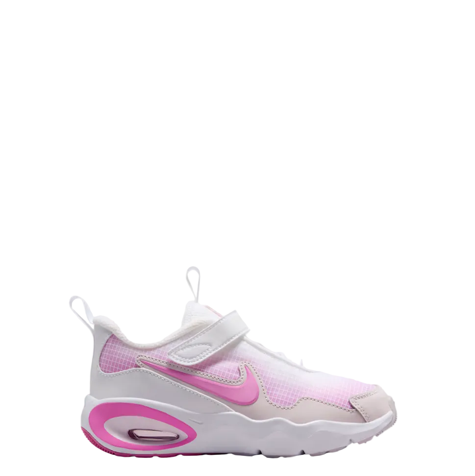 A Nike sneaker in white and light pink, featuring a hook-and-loop strap closure and a pink Swoosh logo, shown against a light gray gradient background.
