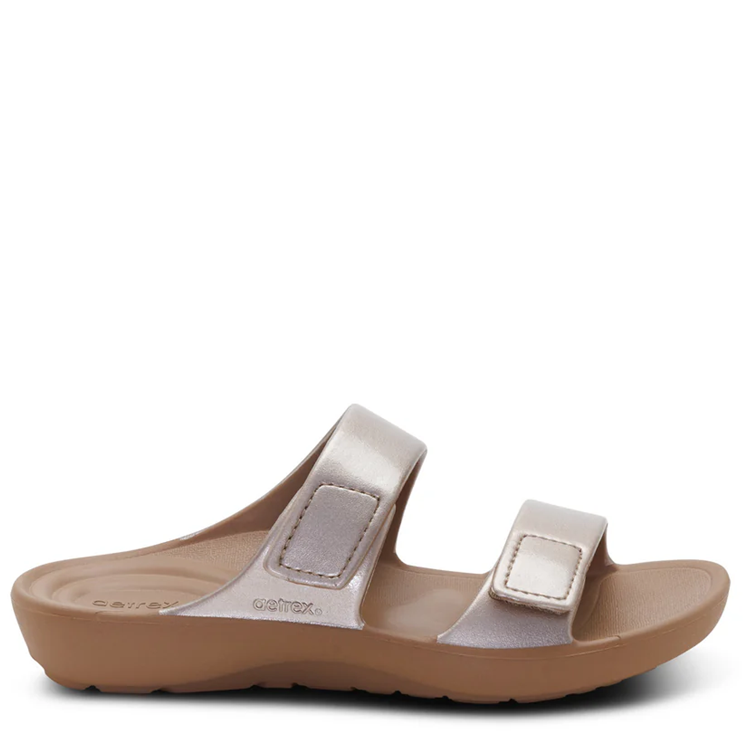 Sandal with brown sole and beige straps on a white background