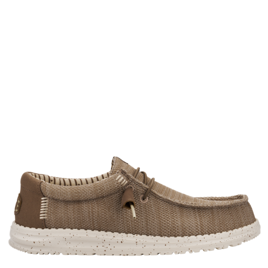 Brown shoe with white sole on a white background