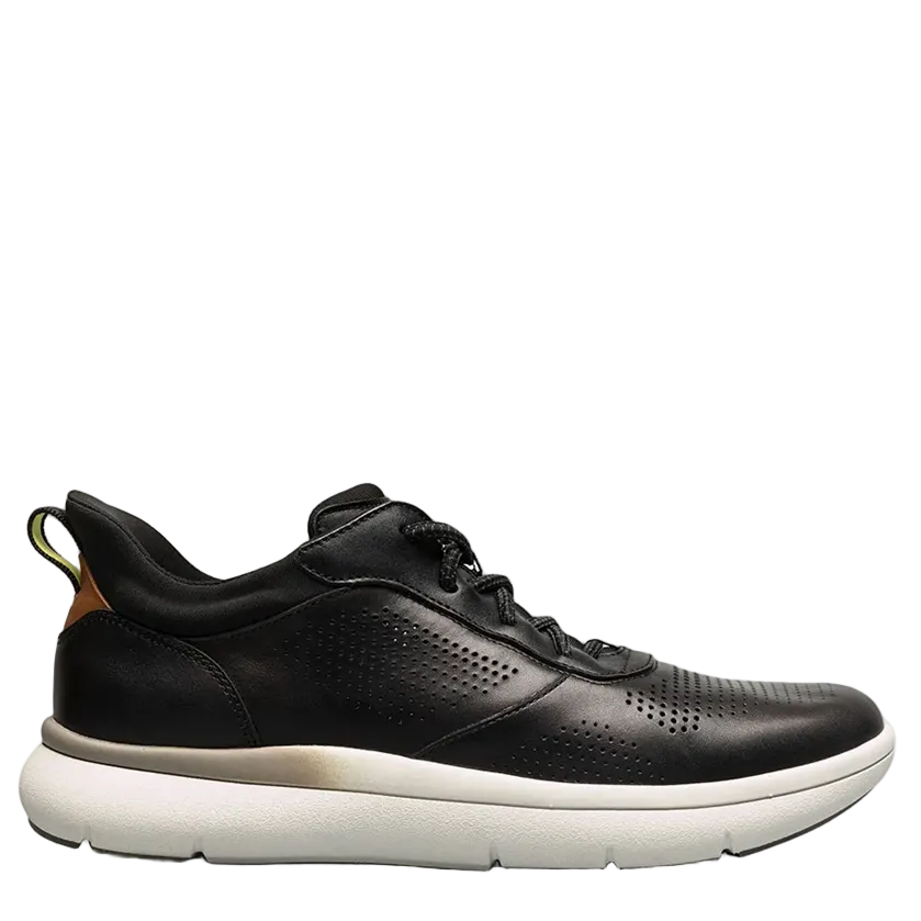 Green sneaker with a beige sole on a light gray background