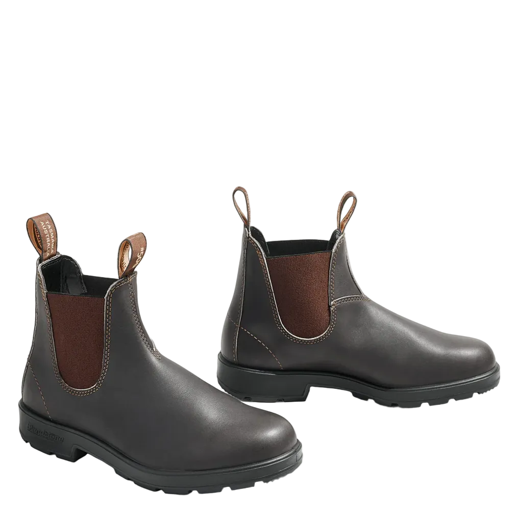A pair of dark brown leather Chelsea boots with brown elastic side panels and pull loops, displayed on a clean off-white background.