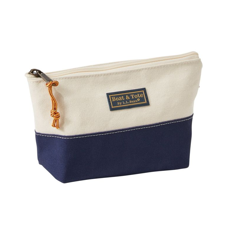 Canvas pouch with navy bottom half and white top half, featuring a brand label on a white background.