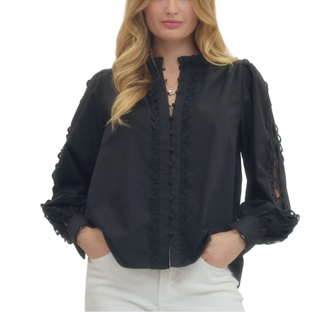 Woman wearing a black blouse with lace details on a white background
