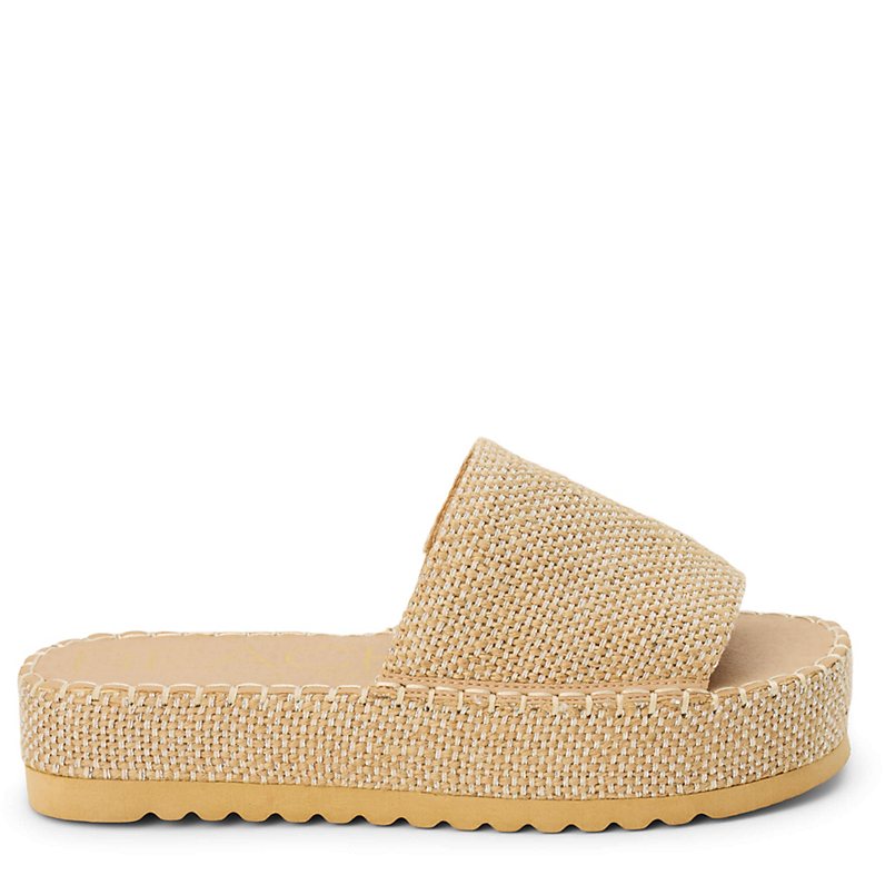 Beige sandal with textured strap on a white background