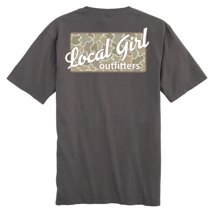 A dark gray t-shirt shown from the back, featuring a graphic print with a camouflage background and white text reading 'Local Girl outfitters'. A yellow 'NEW' badge is in the top-left corner.
