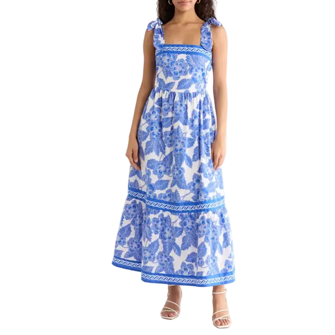 Woman wearing a blue floral dress on a white background