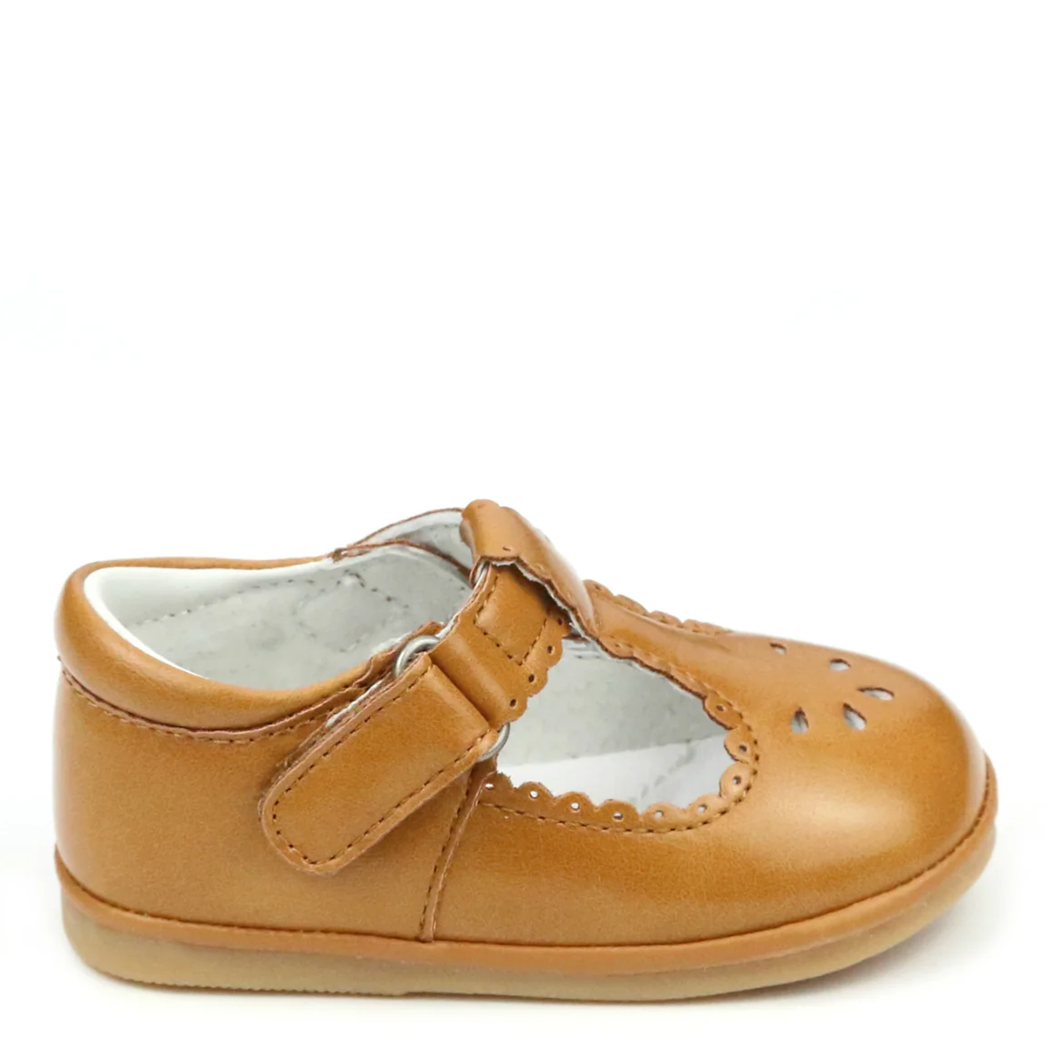 Tan baby shoe with a strap on a white background