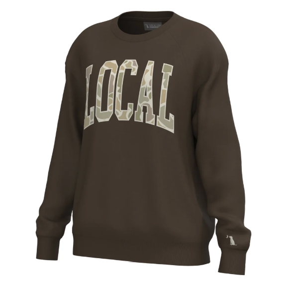 A dark brown crewneck sweatshirt featuring the word 'LOCAL' in arched varsity block letters across the chest, filled with a light beige and green camouflage pattern. The sweatshirt is shown on a clean white background.