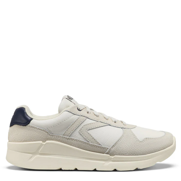 White sneaker with navy accents on a white background