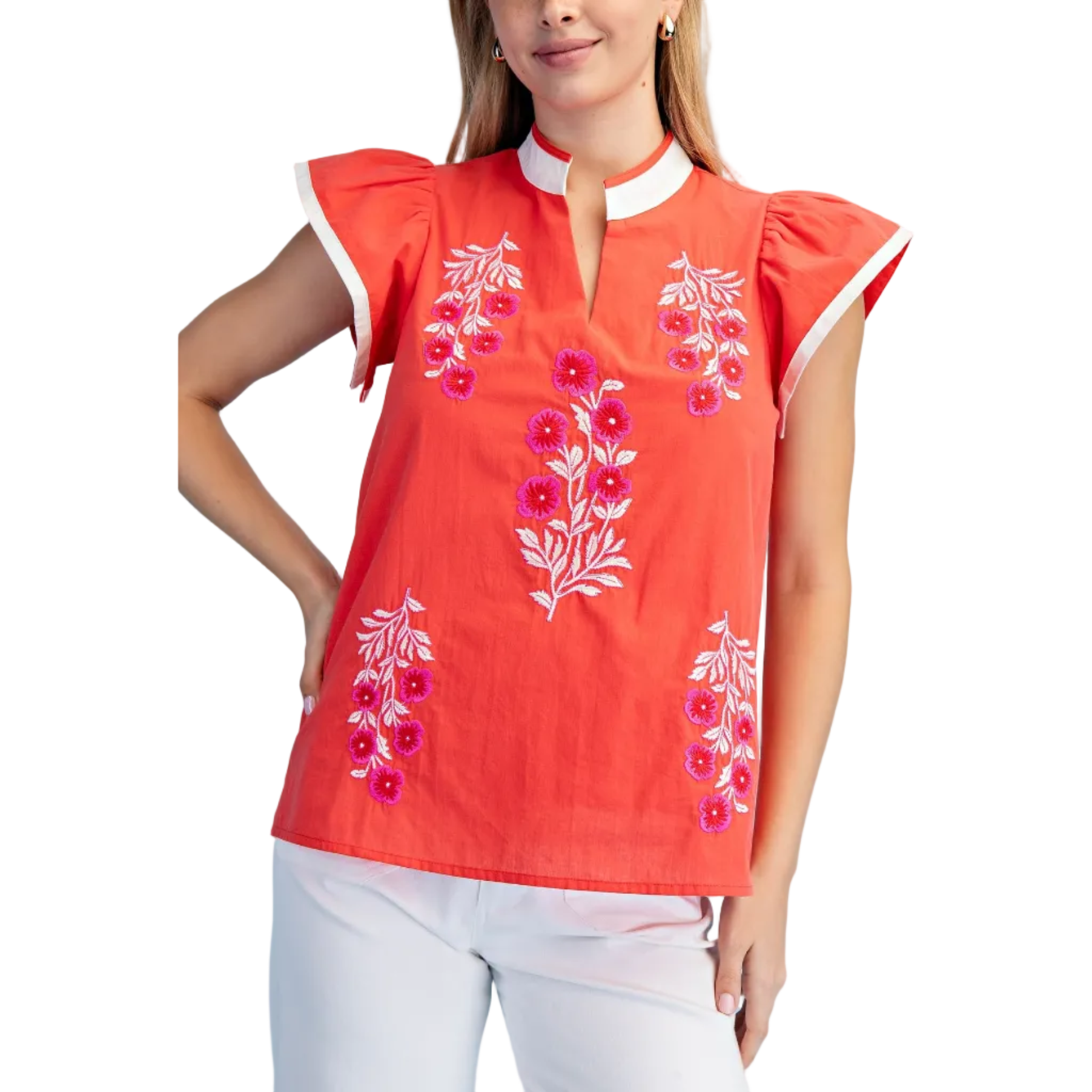 Woman wearing a red embroidered top against a white background